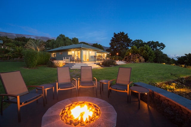 Luxury backyard fire pit at sunset