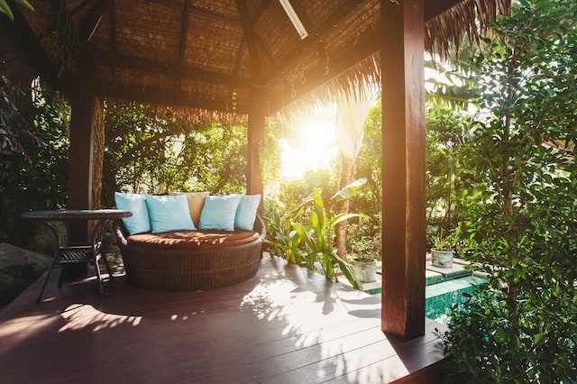 Cozy luxury gazebo chair with pillows in villa yard